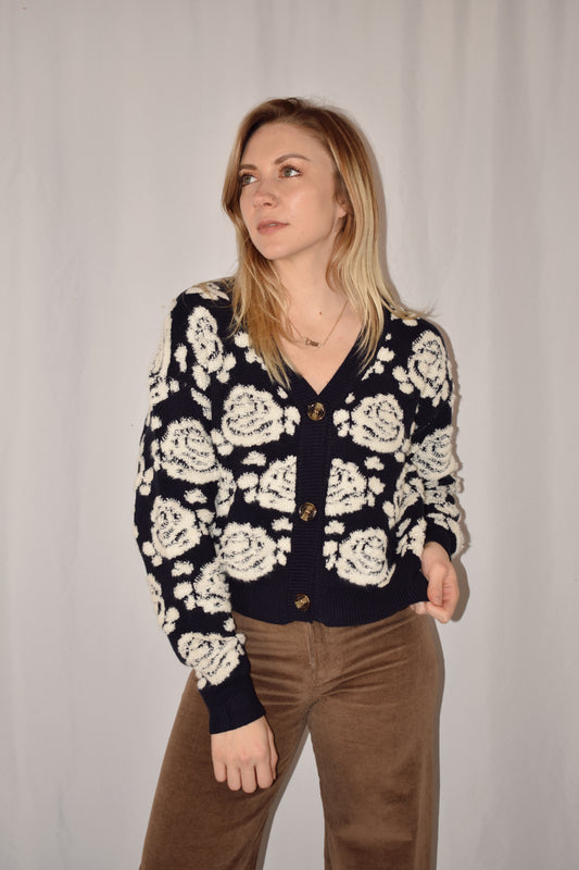 v neck waist length button down cardigan with navy background and ivory textured rose pattern 