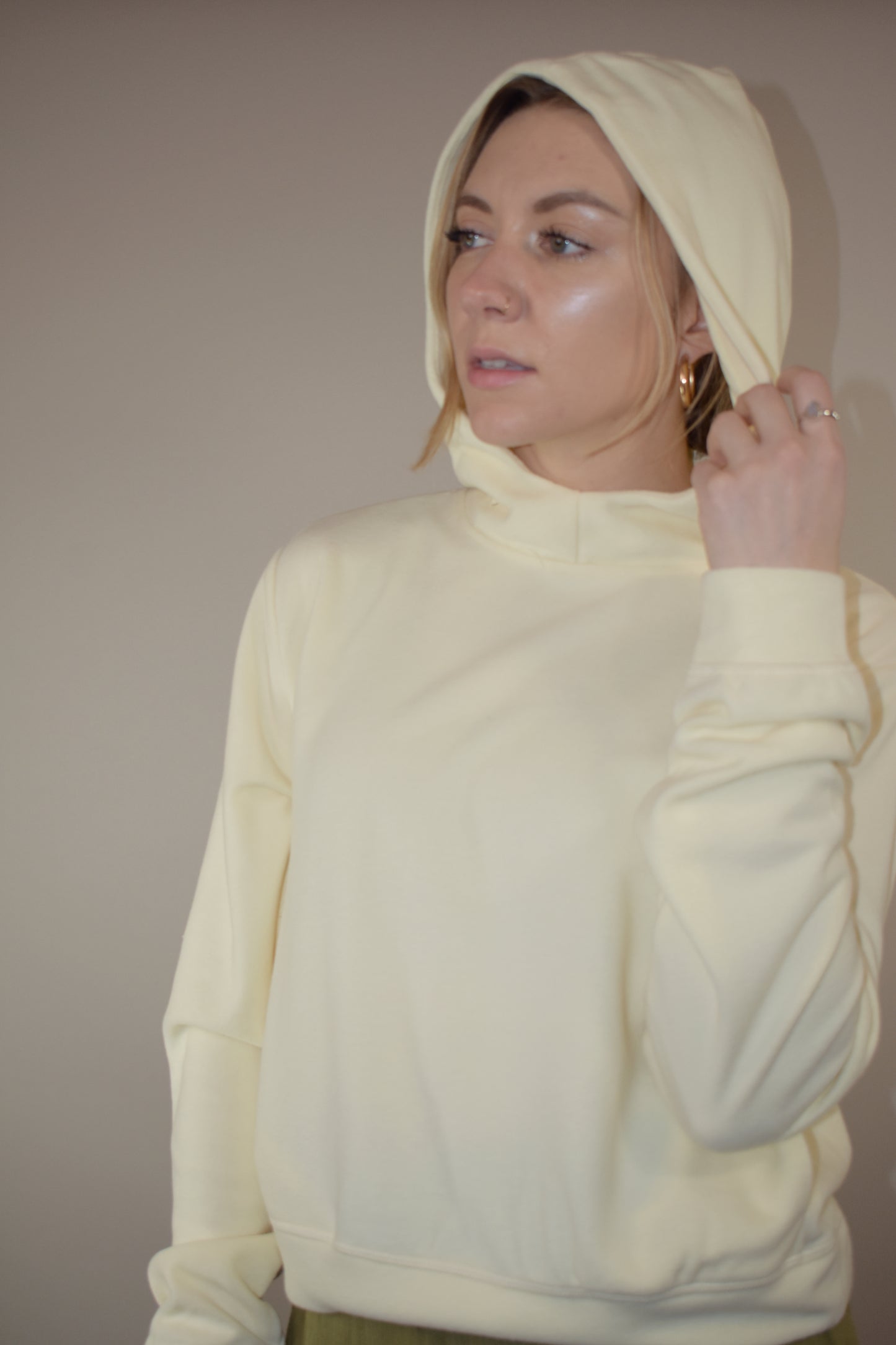 fleece hoodie with slight cowl neck and hood. has pockets that aren't connected. loose fitting full length