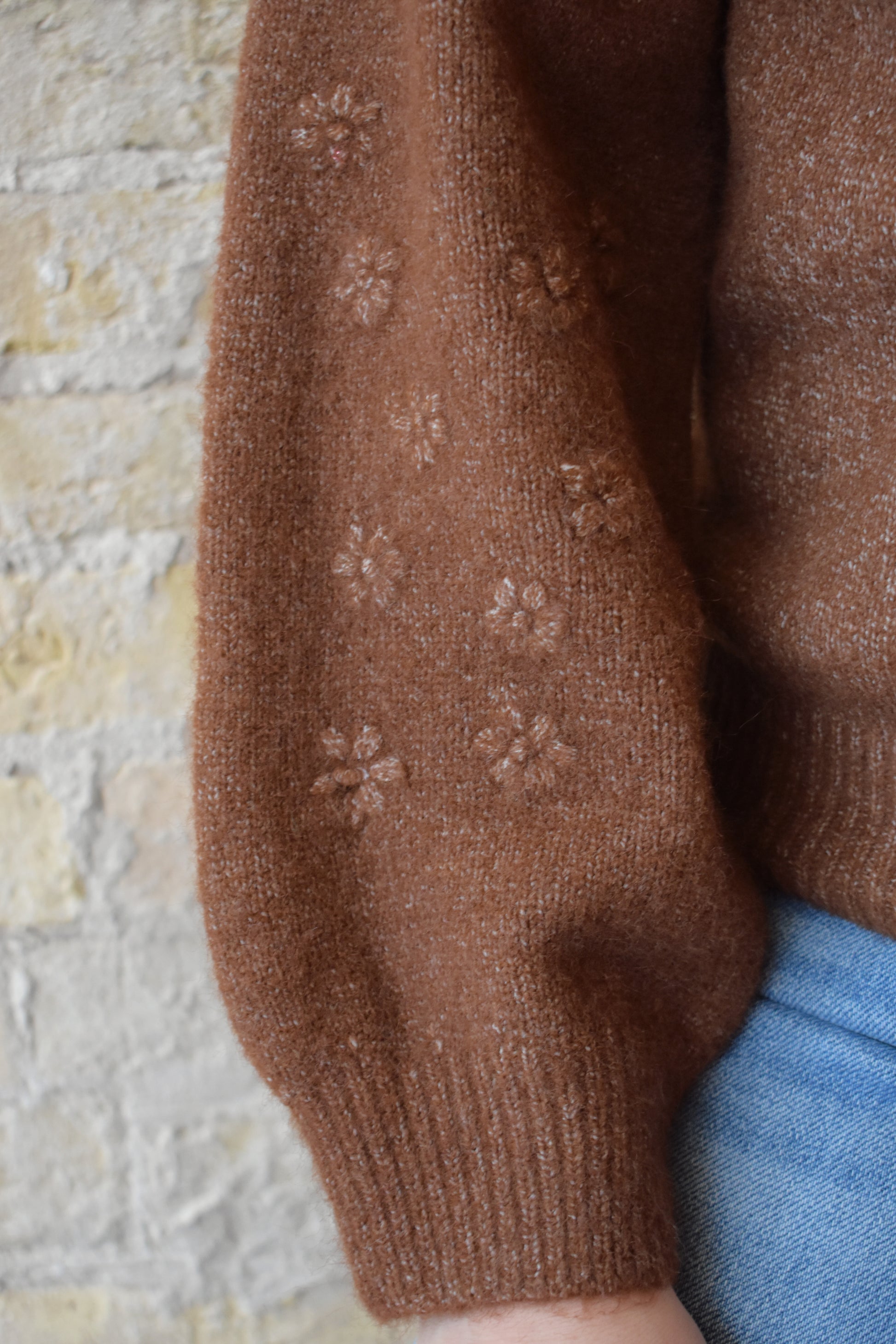 brown crew neck sweater with 3d floral design on sleeves full length ribbed collar cuffs and hem relaxed fit