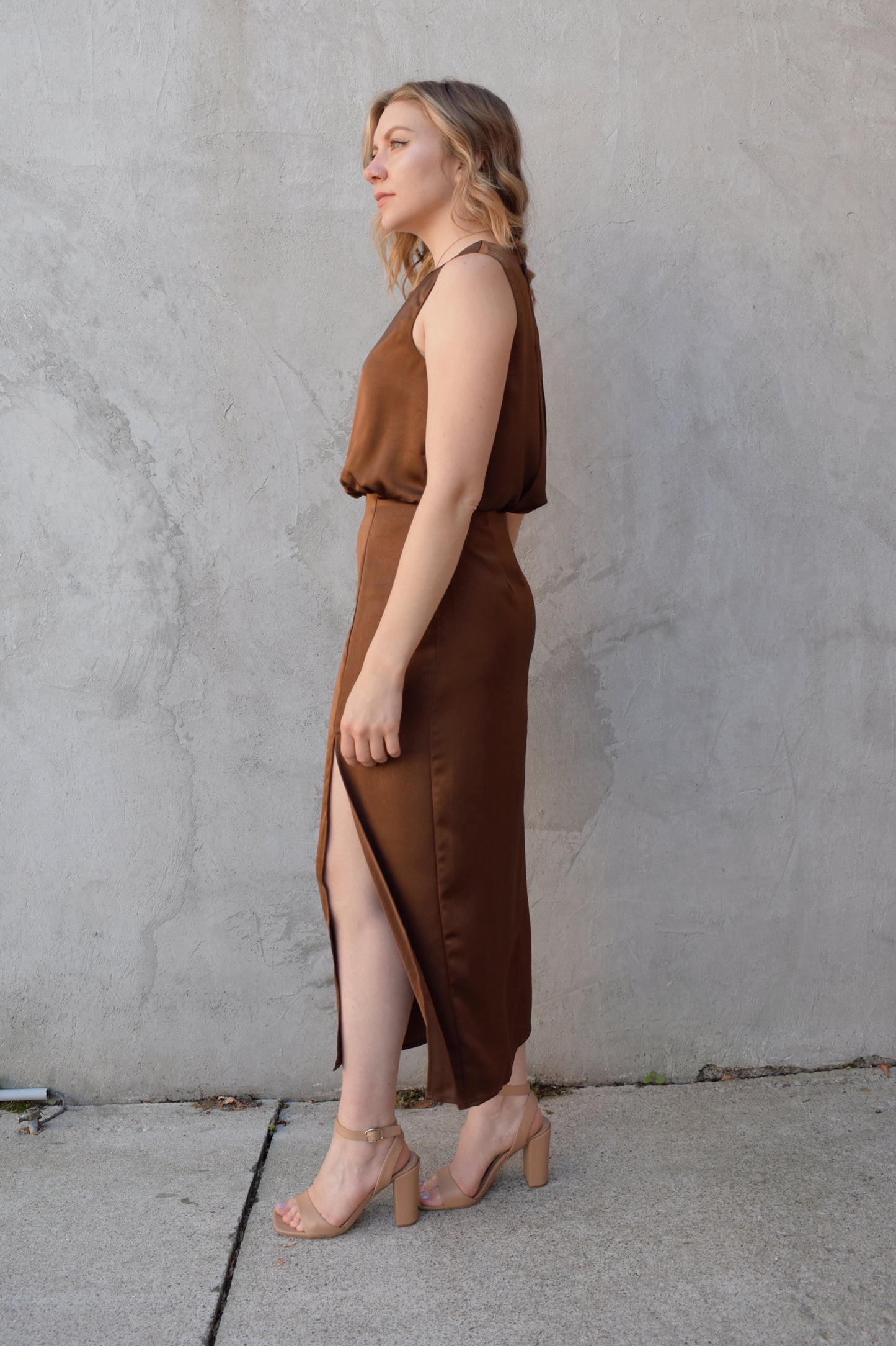 satin bronze midi dress with front side slit fitted waist sleeveless pleated back detail on bodice high neck