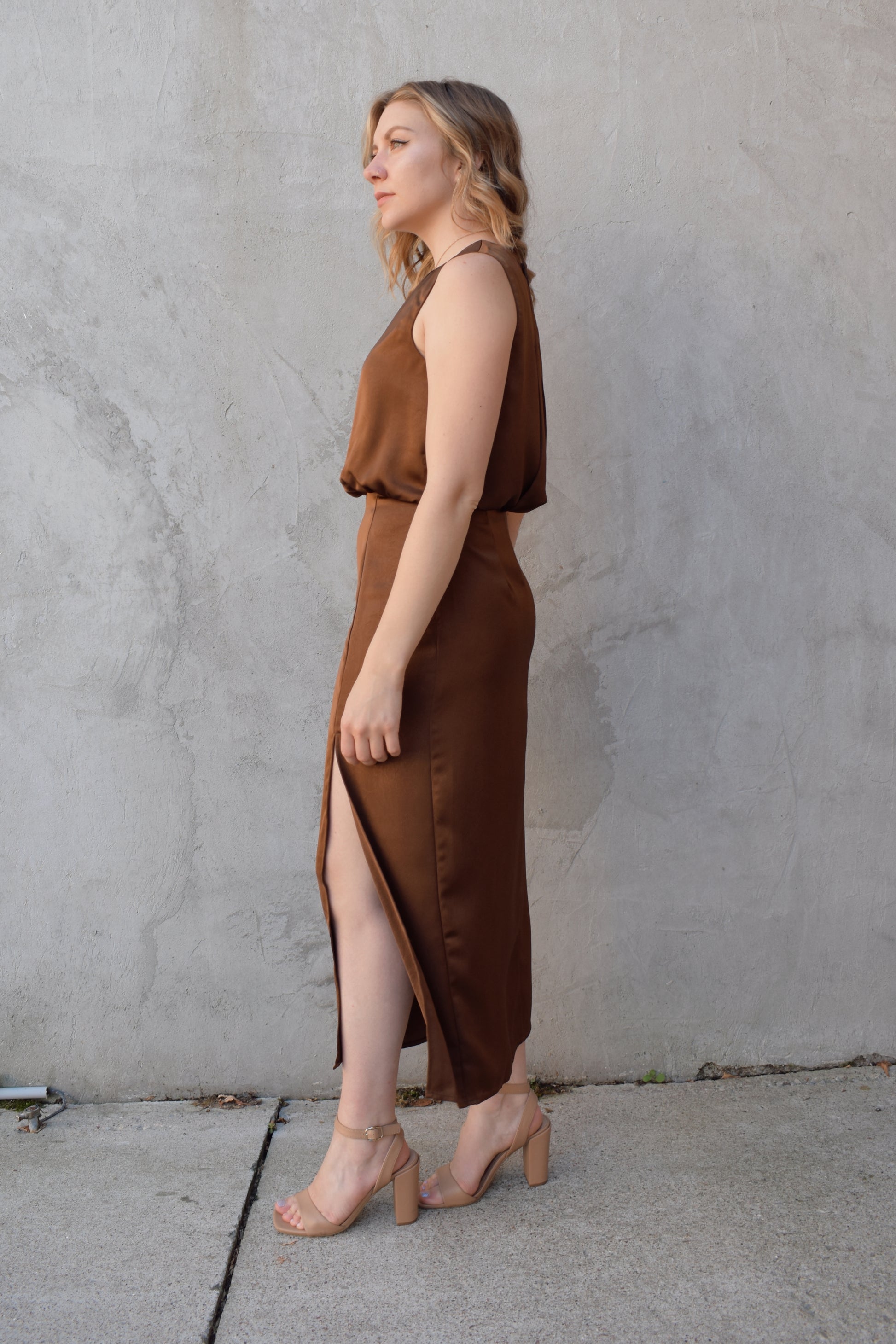 satin bronze midi dress with front side slit fitted waist sleeveless pleated back detail on bodice high neck