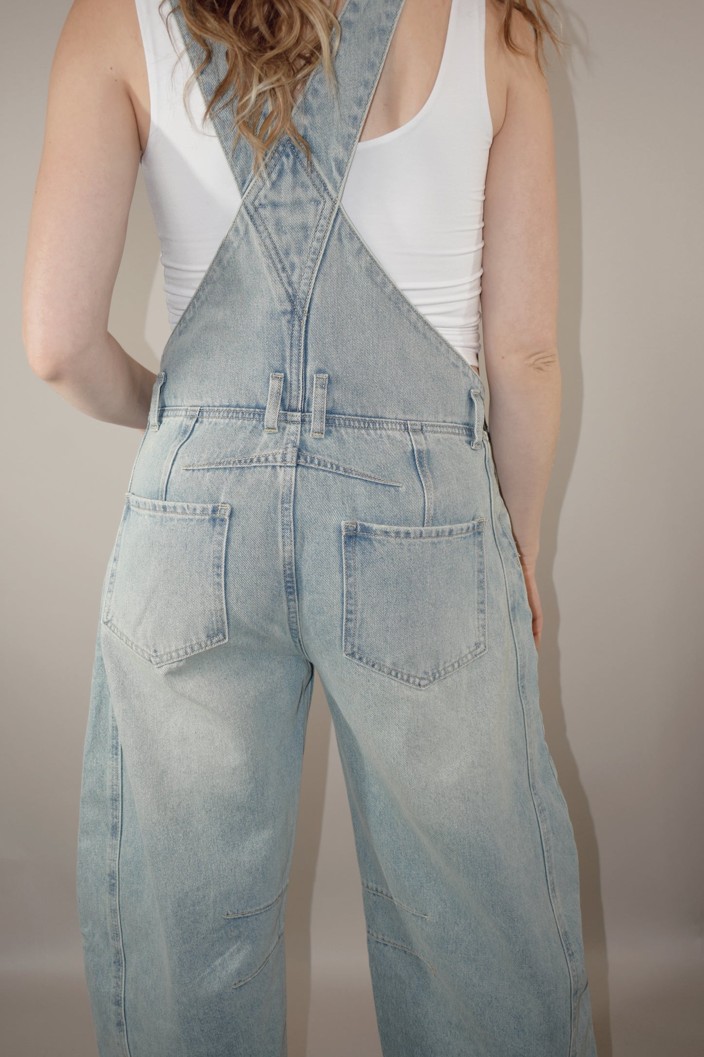 barrel jean overalls with adjustable straps, front and back pockets, beltloops, button side enclosure, front patch pockets, light wash, no holes, seam detailing around knees and back waist