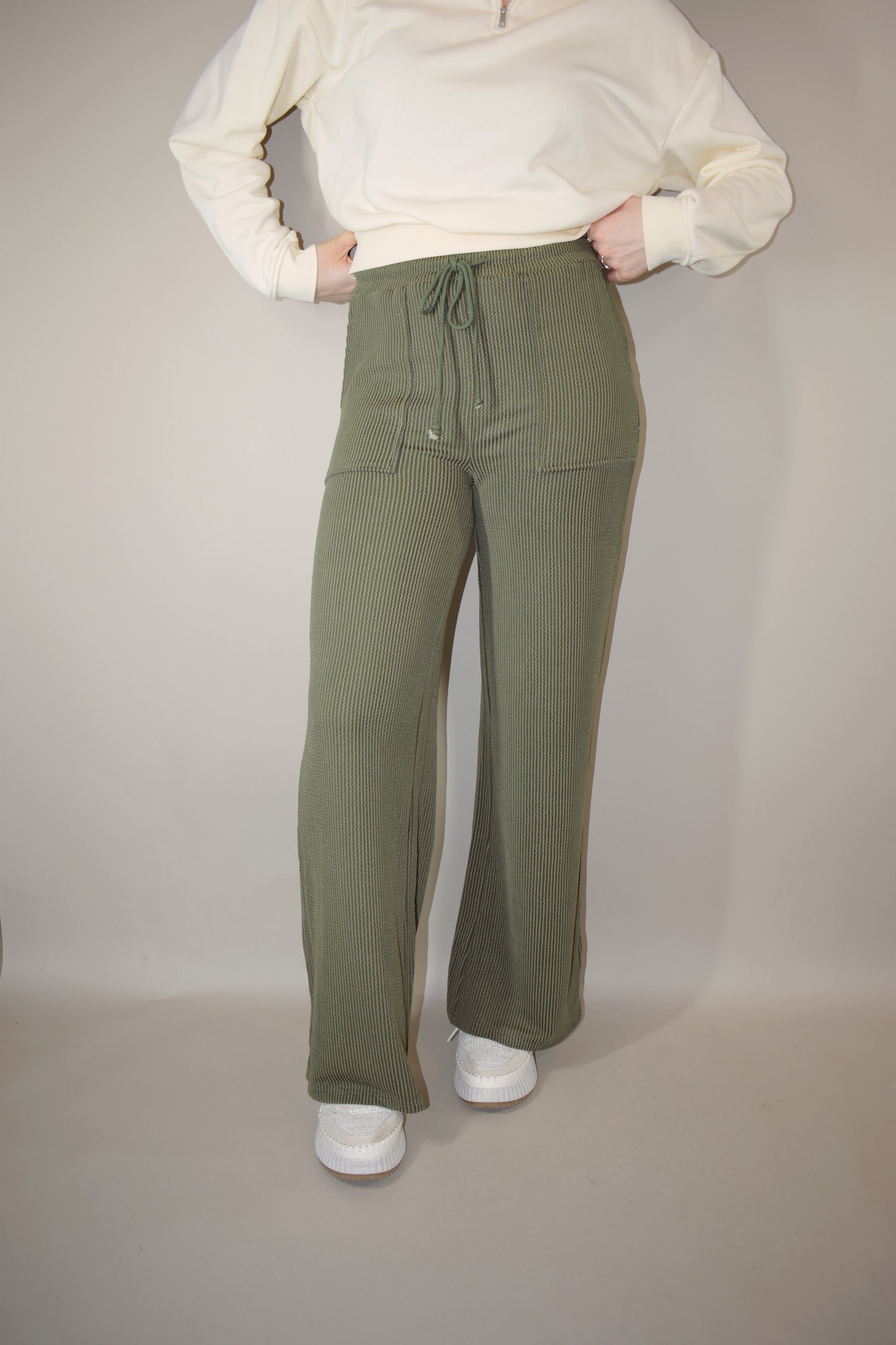 full length high waisted wide leg ribbed olive green athleisure pants with elastic waistband, drawstring, and front pockets.