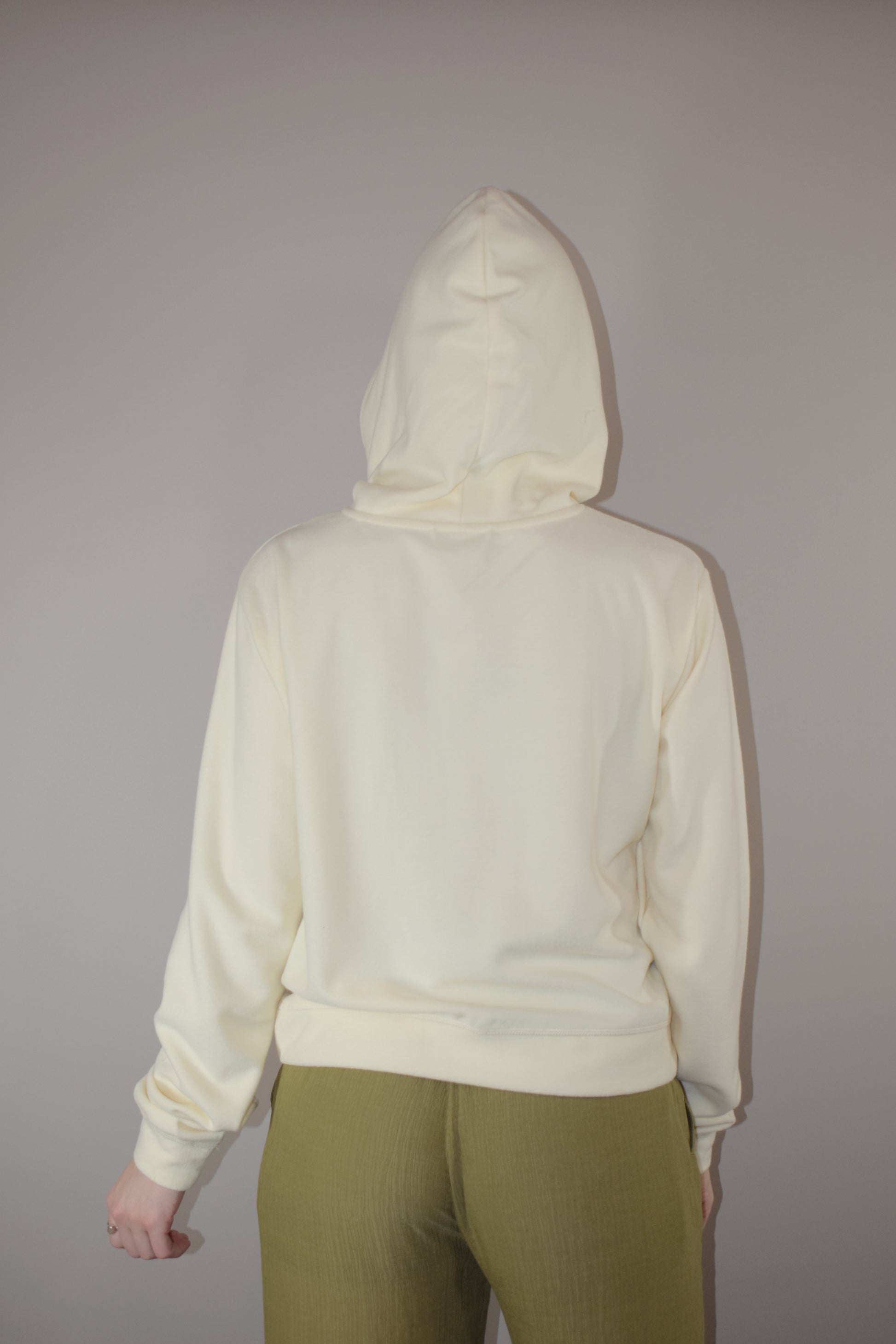 fleece hoodie with slight cowl neck and hood. has pockets that aren't connected. loose fitting full length