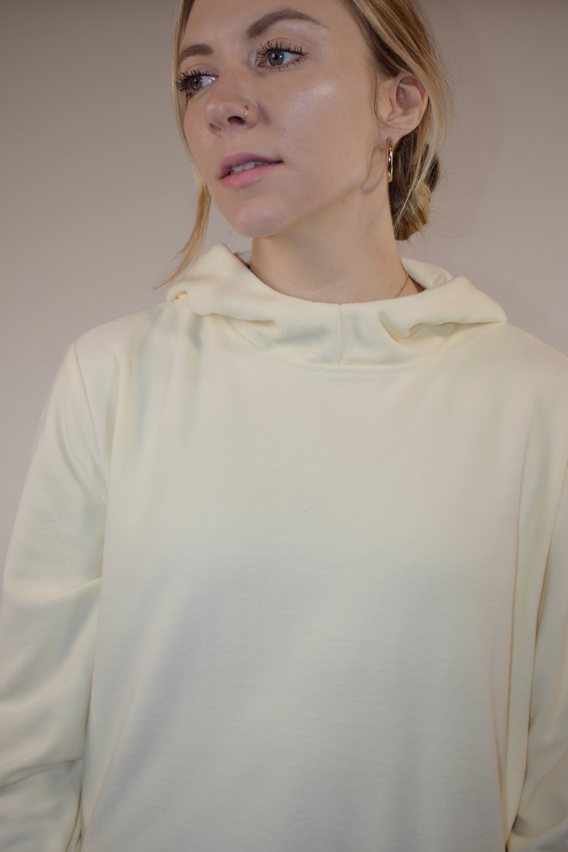 fleece hoodie with slight cowl neck and hood. has pockets that aren't connected. loose fitting full length