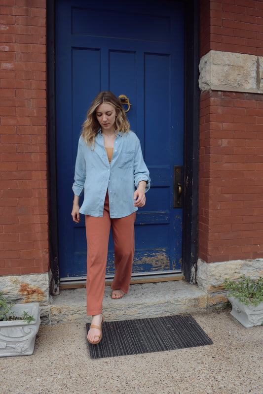 tencel denim chambray button down shirt, oversized relaxed fit, delicate floral embroidery accents same color as button down, one breast patch pocket, sleeves have button for roll up option