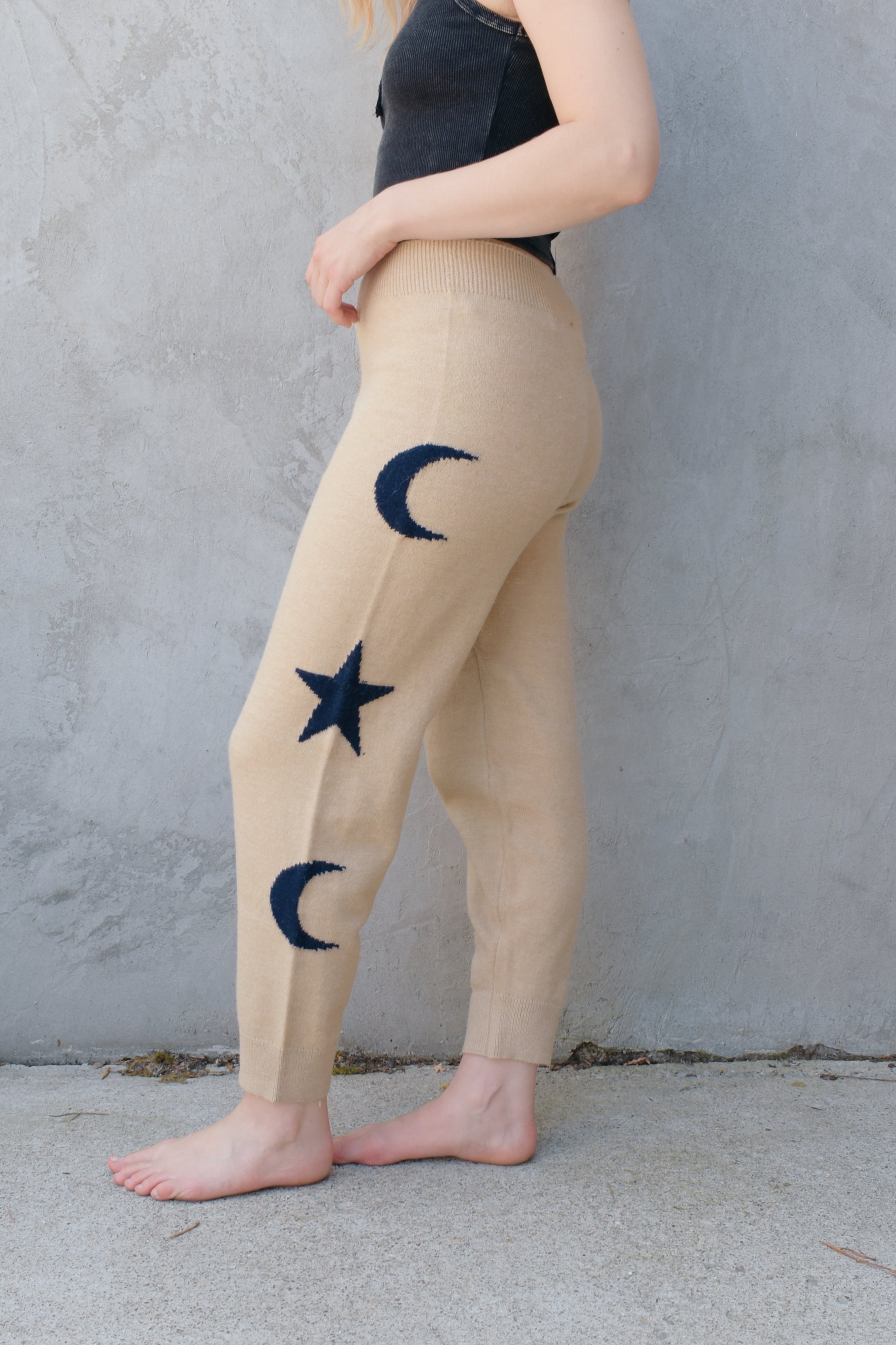 cream knit joggers with slightly elastic wide waistband, high waisted, moon and star design on sides of leg, relaxed fit, no pockets