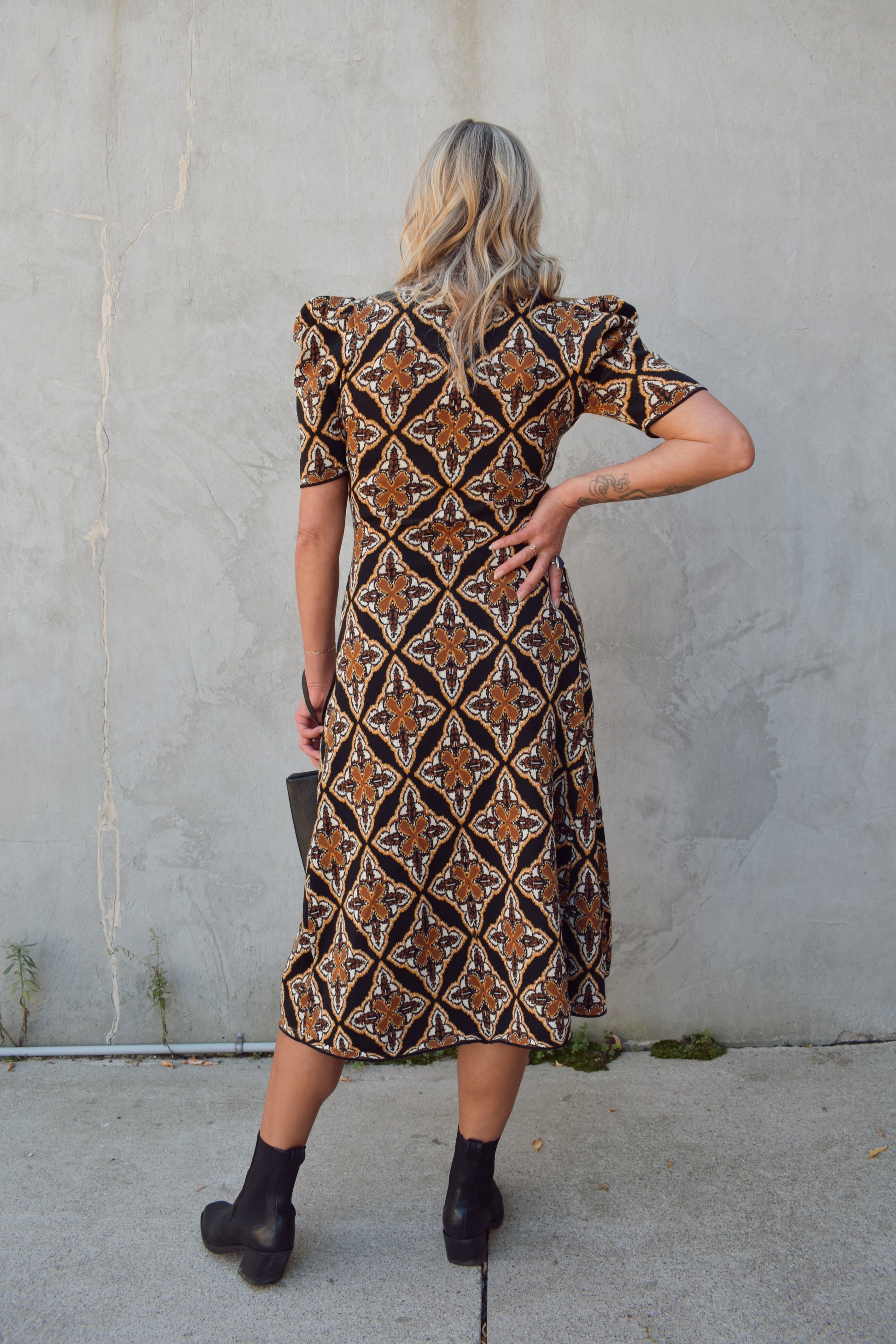 ornamental jacquard sweater midi dress, fitted through bodice and hips, A line skirt, high neck, stretchy, short sleeves that hit at low bicep with puff shoulder structure.