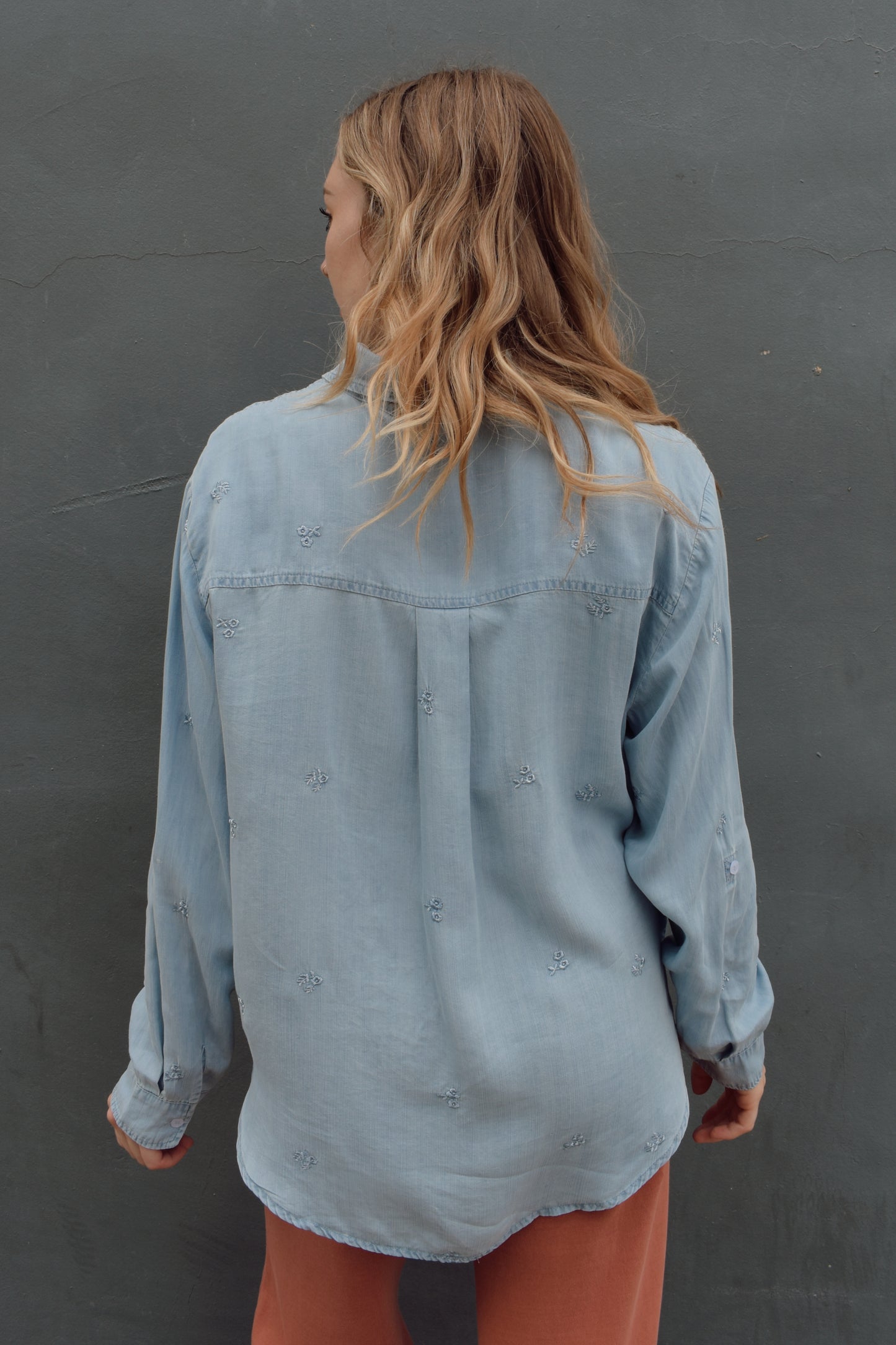 tencel denim chambray button down shirt, oversized relaxed fit, delicate floral embroidery accents same color as button down, one breast patch pocket, sleeves have button for roll up option