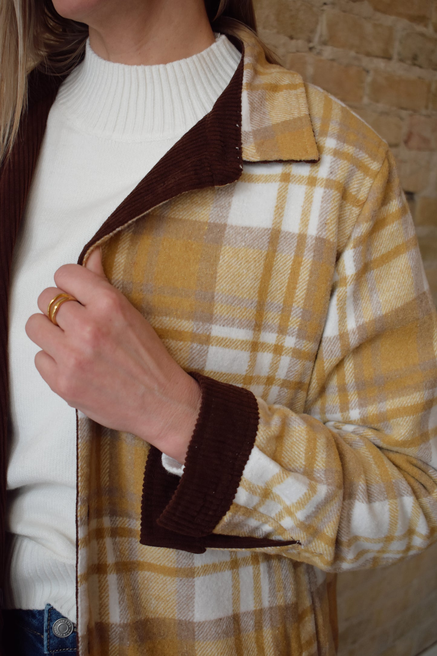dark brown corduroy shacket lined with mustard color plaid flannel, reversible, one side has breast pockets the other has side front pockets, button down, relaxed fit full length