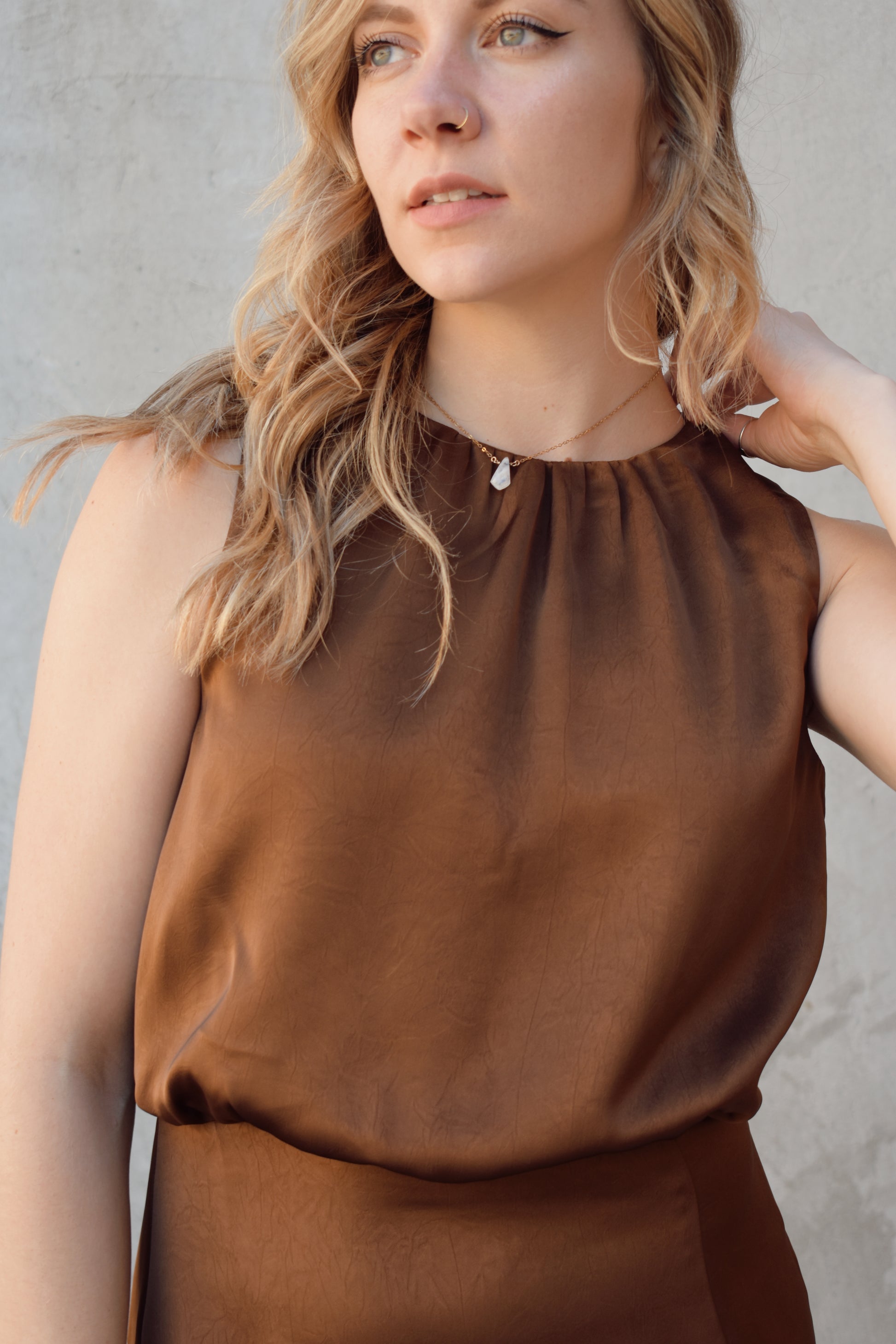 satin bronze midi dress with front side slit fitted waist sleeveless pleated back detail on bodice high neck