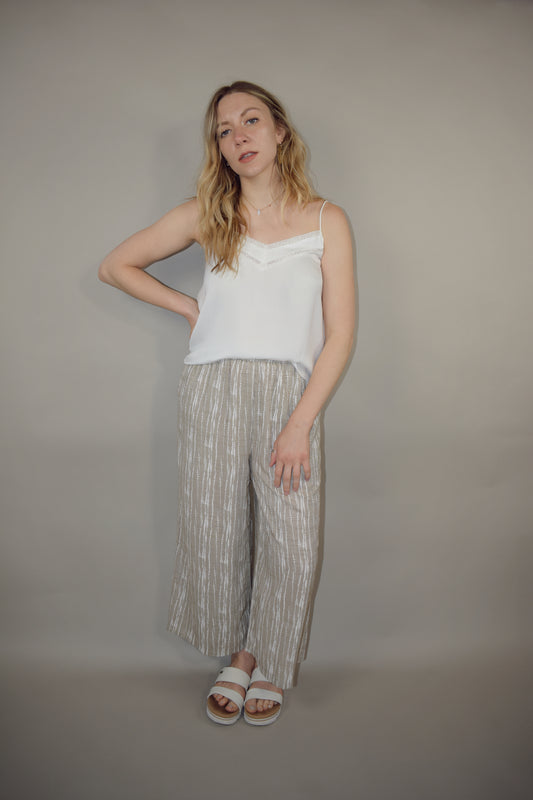 flowy cream and white printed pants slightly cropped, elastic waistband, has pockets, lightweight