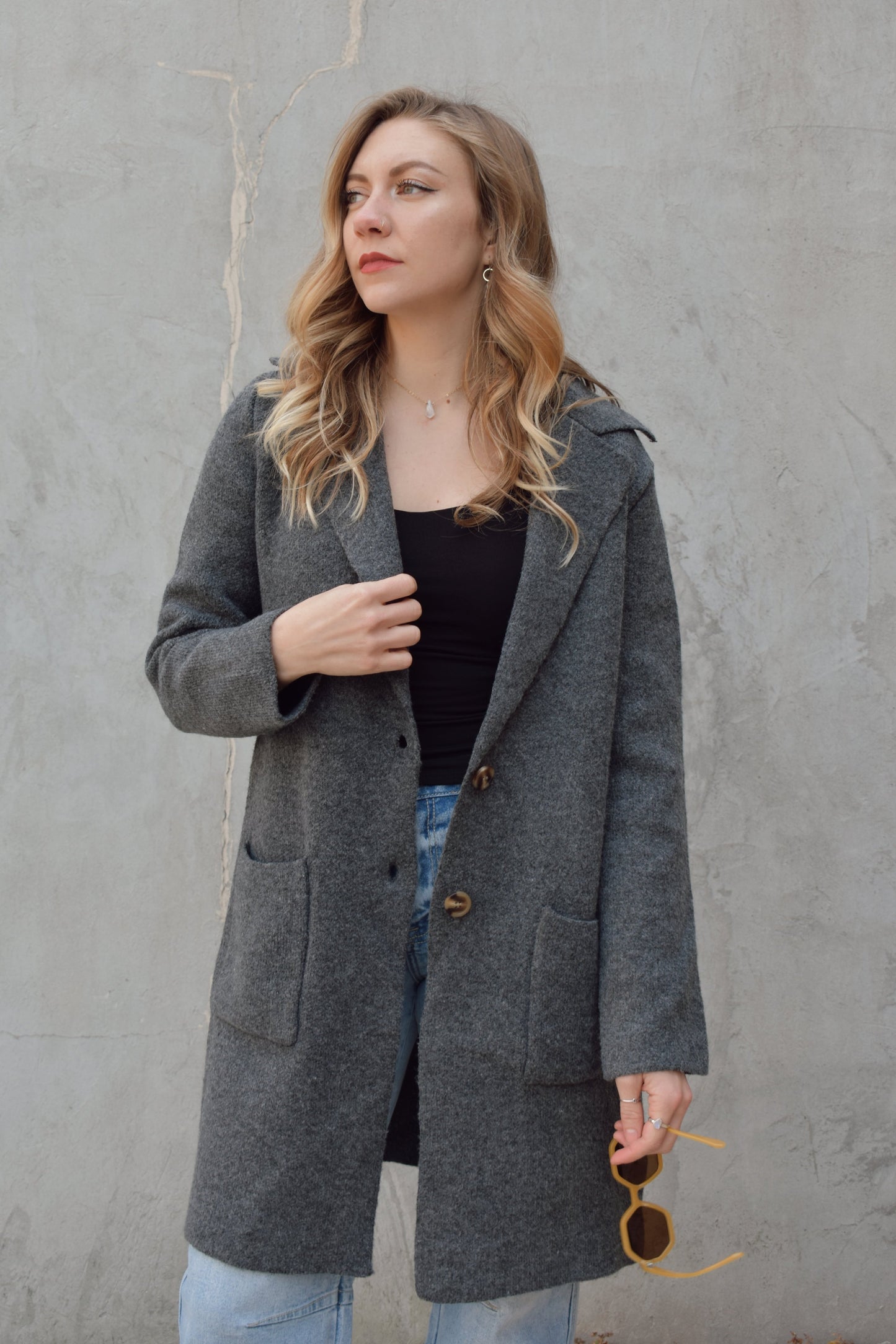 pea coat style cardigan with notched collar two button enclosure front patch pockets, hits above the knee.