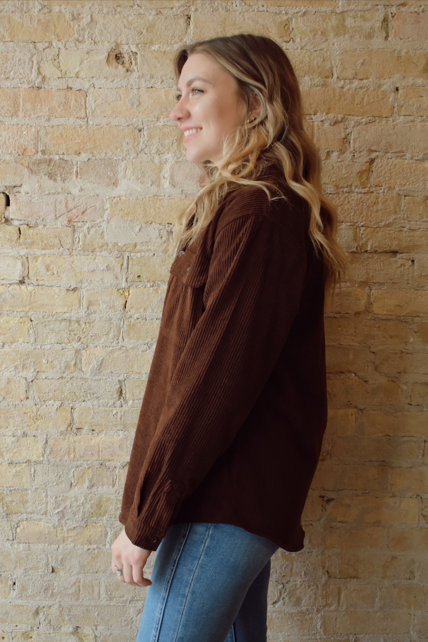 dark brown corduroy shacket lined with mustard color plaid flannel, reversible, one side has breast pockets the other has side front pockets, button down, relaxed fit full length