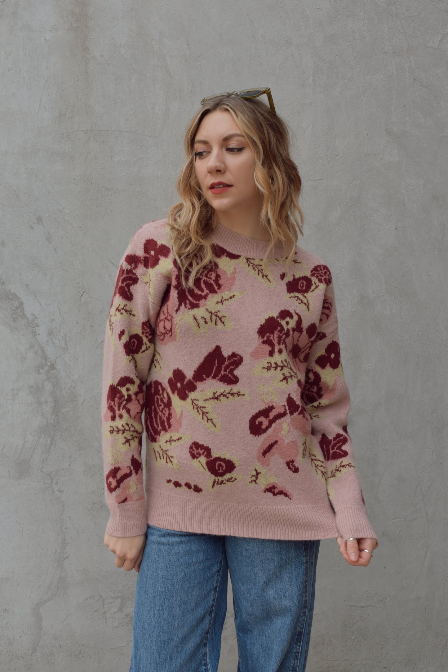 crew neck sweater full length relaxed fit drop shoulder with dusty rose background and floral and leaf design in shades of red pink and light green 