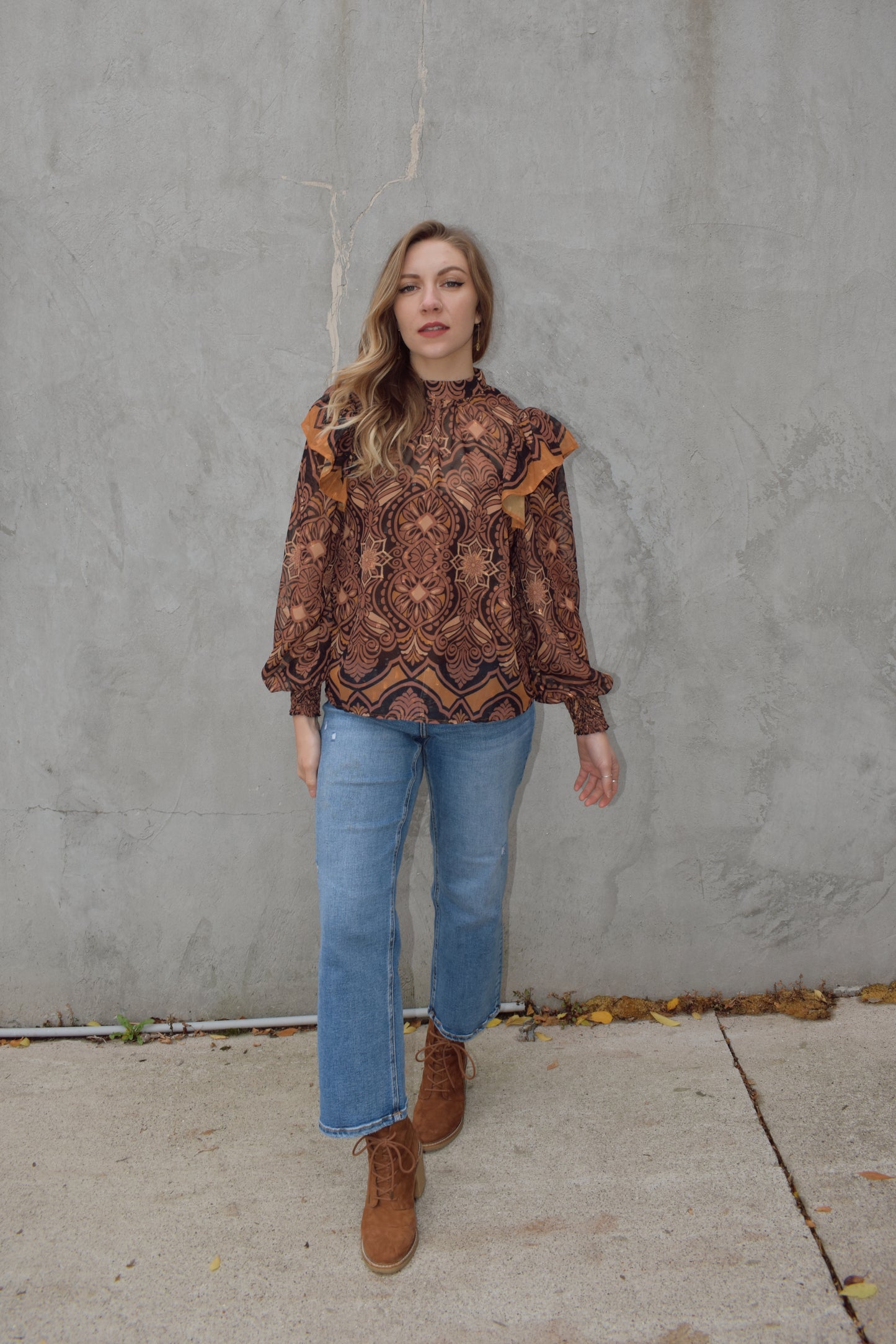 Sheer blouse with cami built in underneath. long balloon sleeve with smocked cuffs and separate ruffle detail on shoulders. mock neck with two button enclosure at back of neck. full length and loose fit. vintage pattern with gold threading throughout.