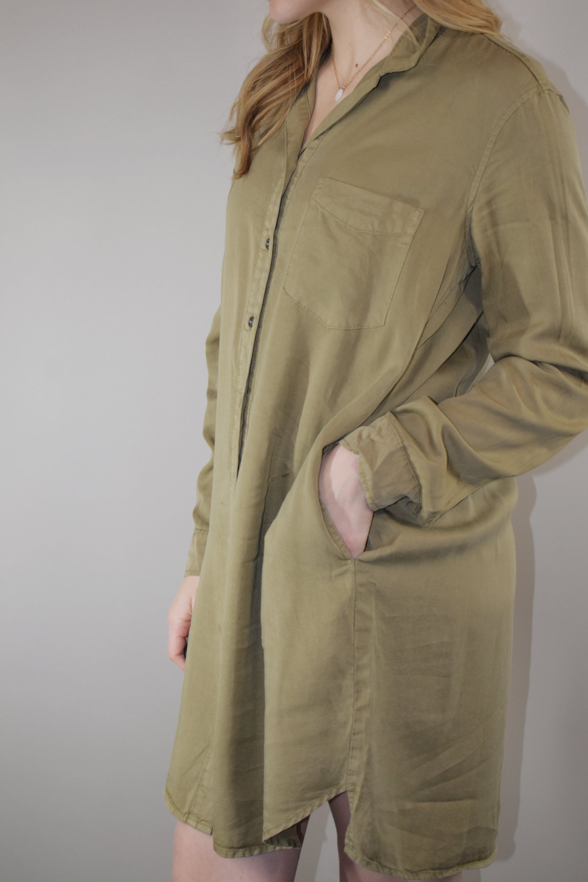 olive tencel button down collared mini dress with long sleeves with cuff option and one patch breast pocket high low hem 