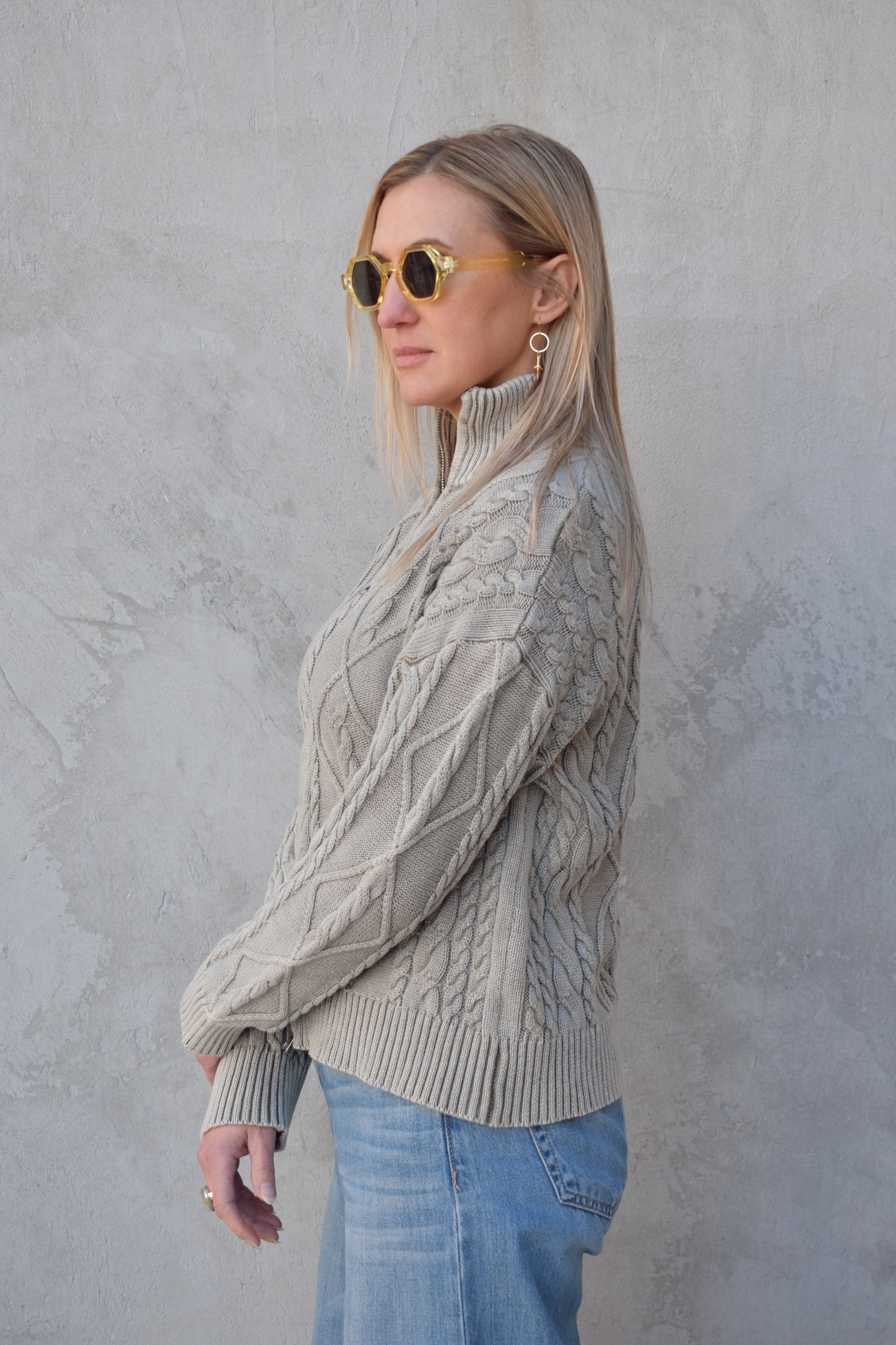 light gray twisted cable high neck sweater with front zip enclosure and it zips from both ways. ribbed cuffs, neck, and hem. drop shoulders.