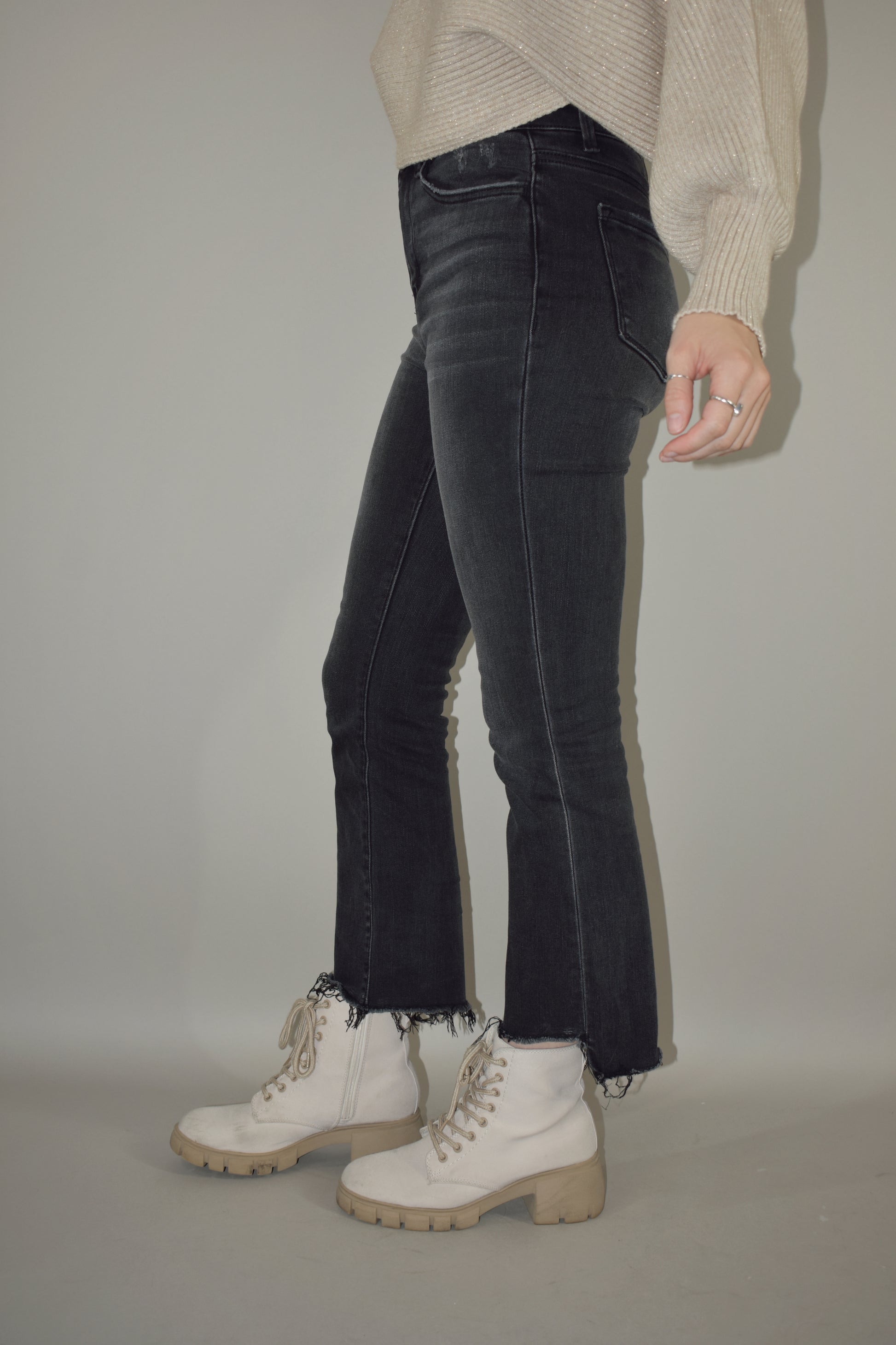 high waisted stretch washed black denim jeans cropped with uneven raw hem and has a straight fit with no holes