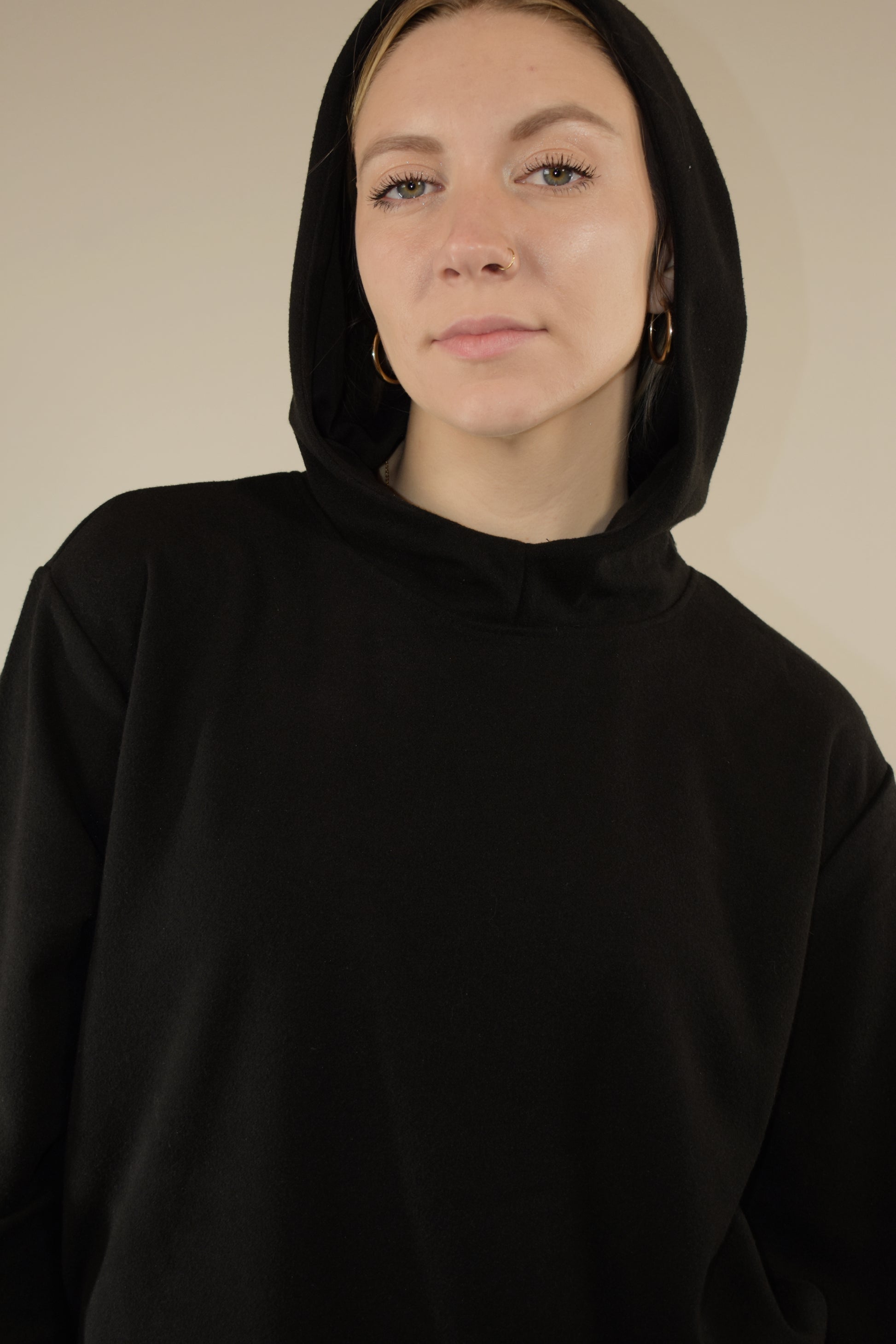 fleece hoodie with slight cowl neck and hood. has pockets that aren't connected. loose fitting full length