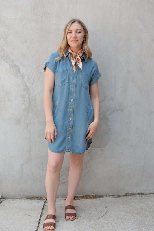 short sleeve button down denim colored medium wash mini dress straight fit has front pockets and patch breast pockets has collar and buttons down the whole front