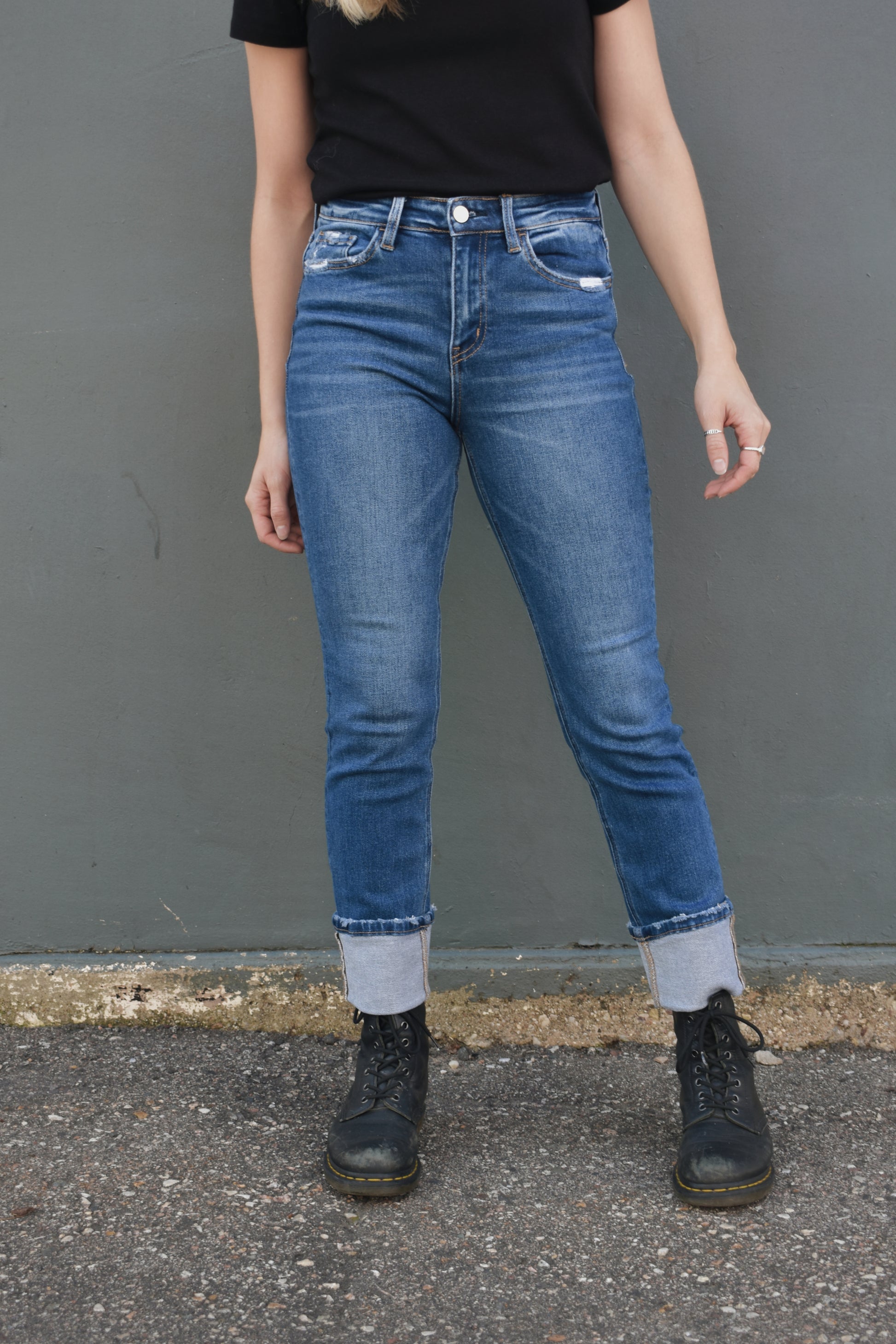 medium wash straight jeans with thick cuff, no holes, light distressing around pockets and at hem, stretch denim