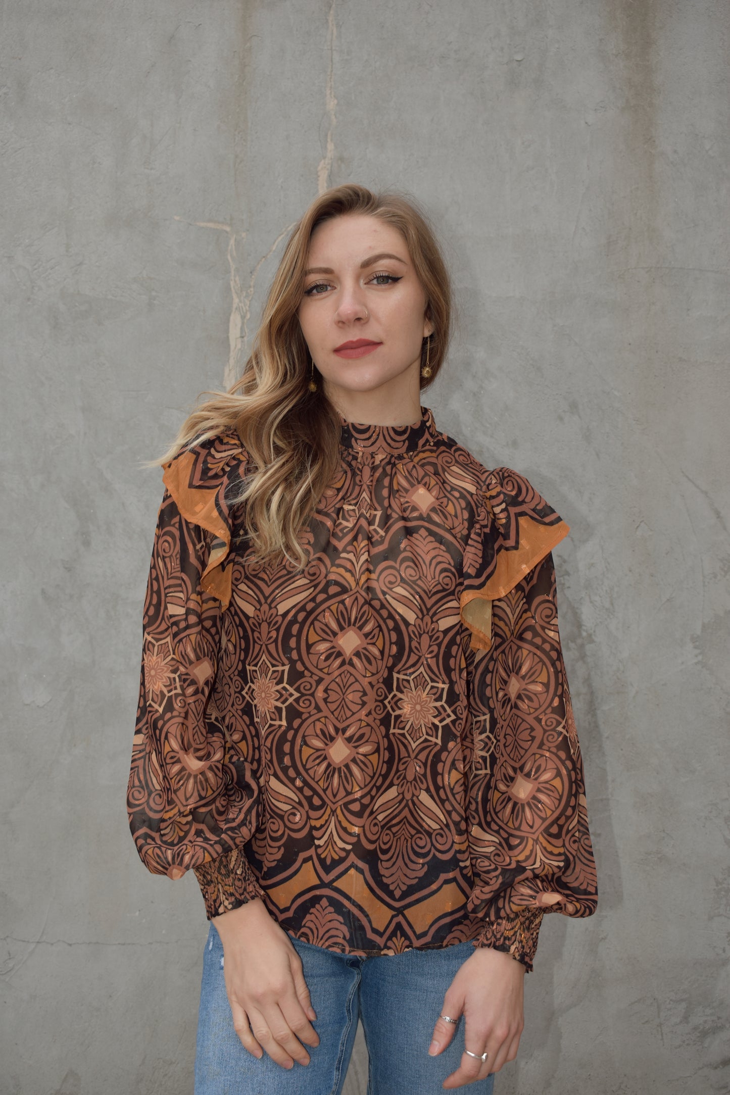 Sheer blouse with cami built in underneath. long balloon sleeve with smocked cuffs and separate ruffle detail on shoulders. mock neck with two button enclosure at back of neck. full length and loose fit. vintage pattern with gold threading throughout.