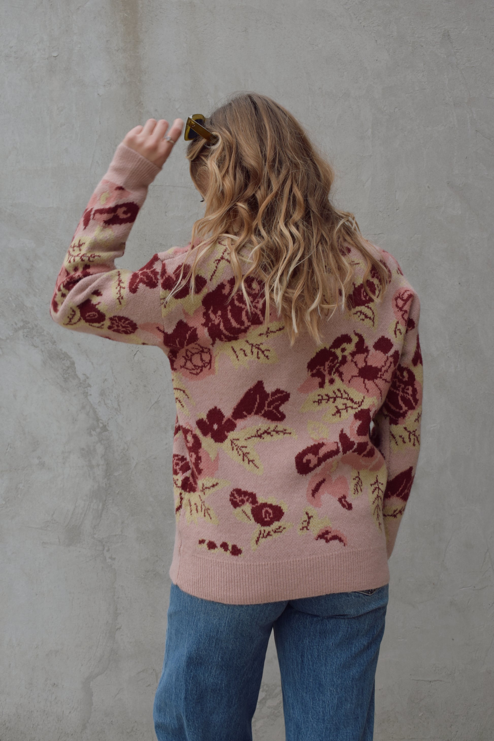 crew neck sweater full length relaxed fit drop shoulder with dusty rose background and floral and leaf design in shades of red pink and light green 