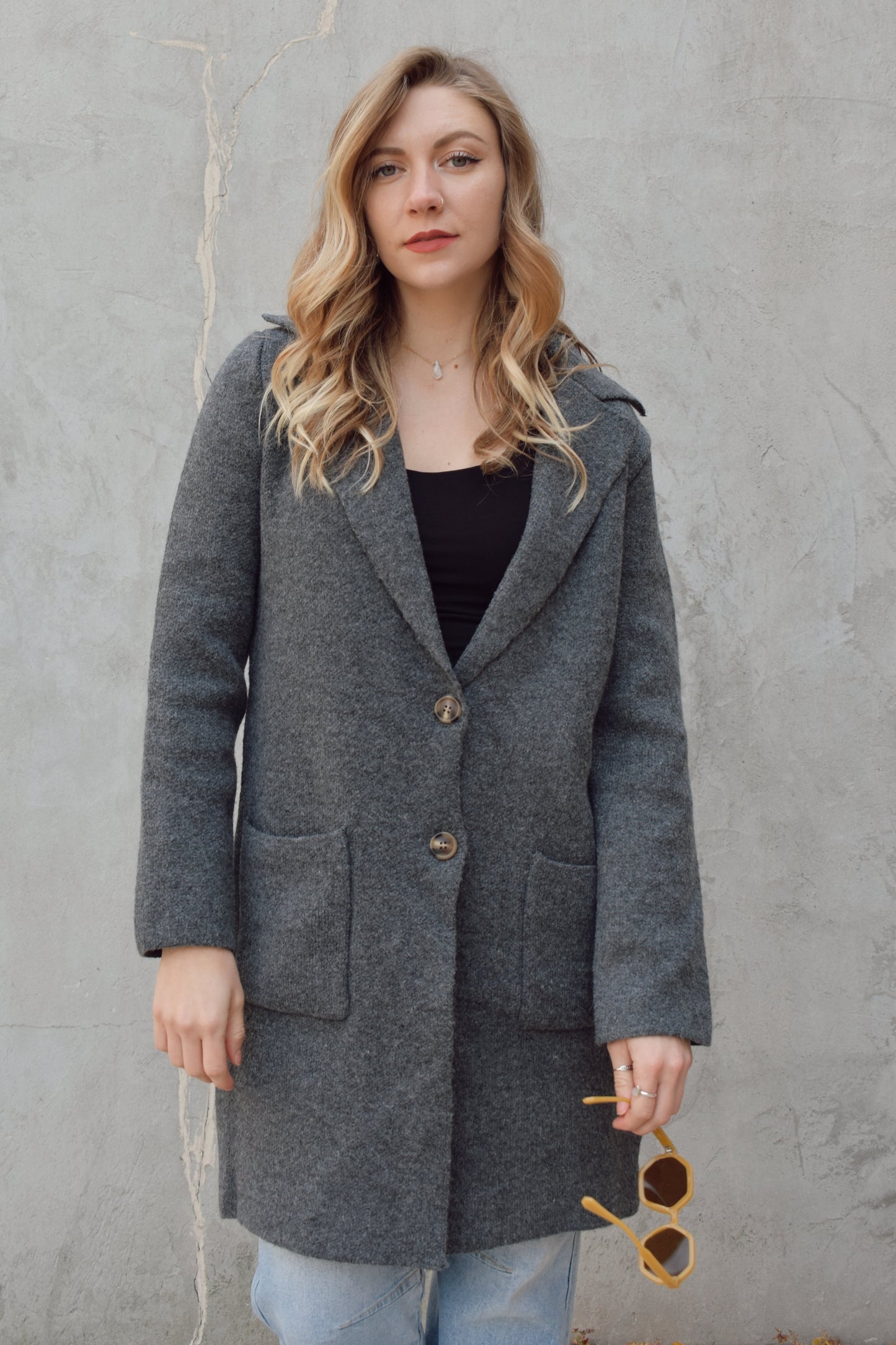 pea coat style cardigan with notched collar two button enclosure front patch pockets, hits above the knee.