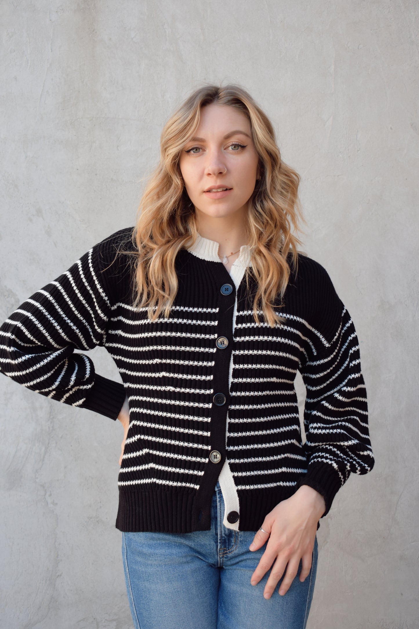 black and white button down cardigan with horizontal stripes drop shoulder balloon sleeves straight fit full length solid white neckline solid black cuffs and hem