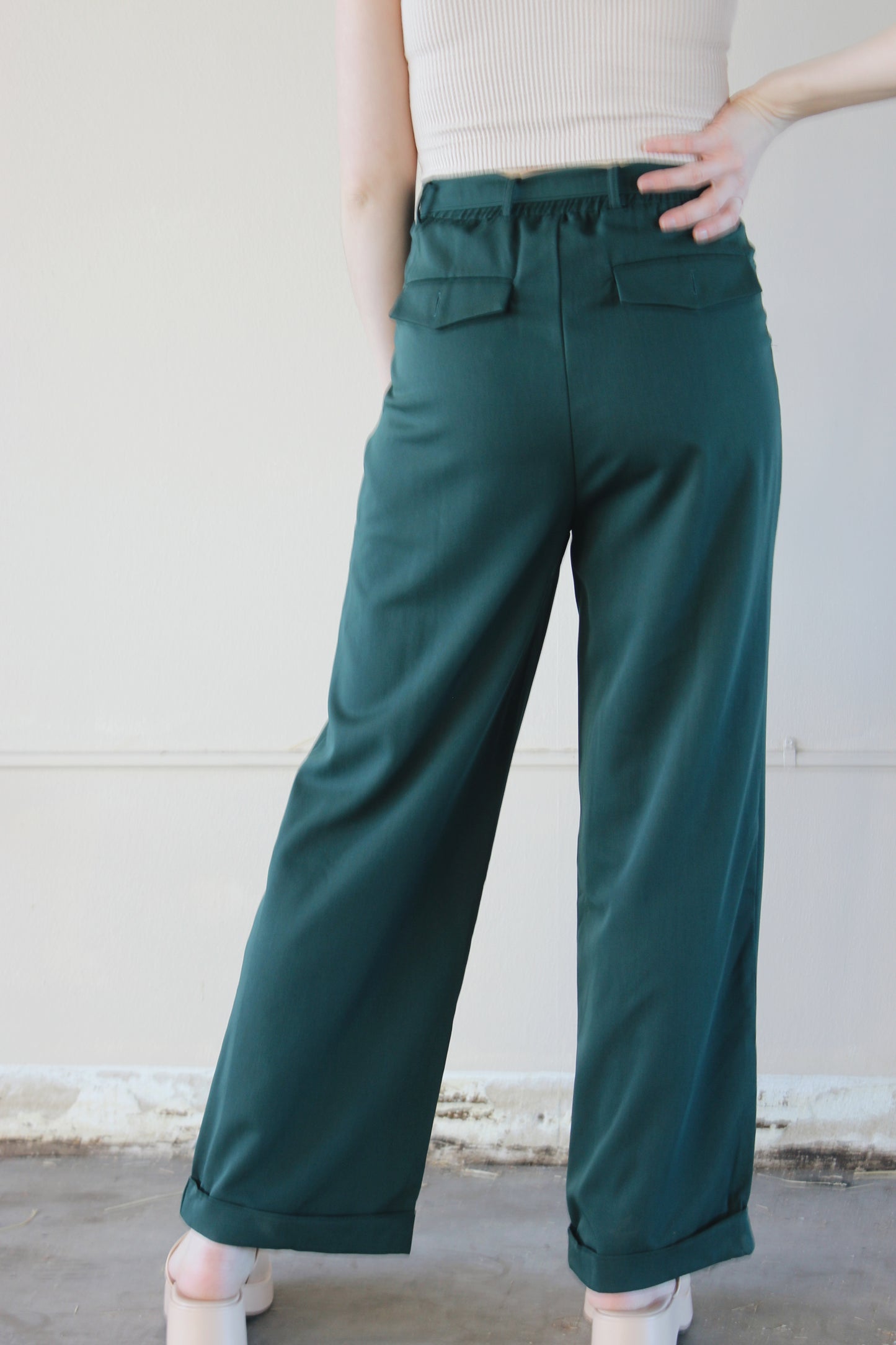 straight leg belted trousers with cuffed hem, front pockets with front pleats, back pockets with flap and button enclosure