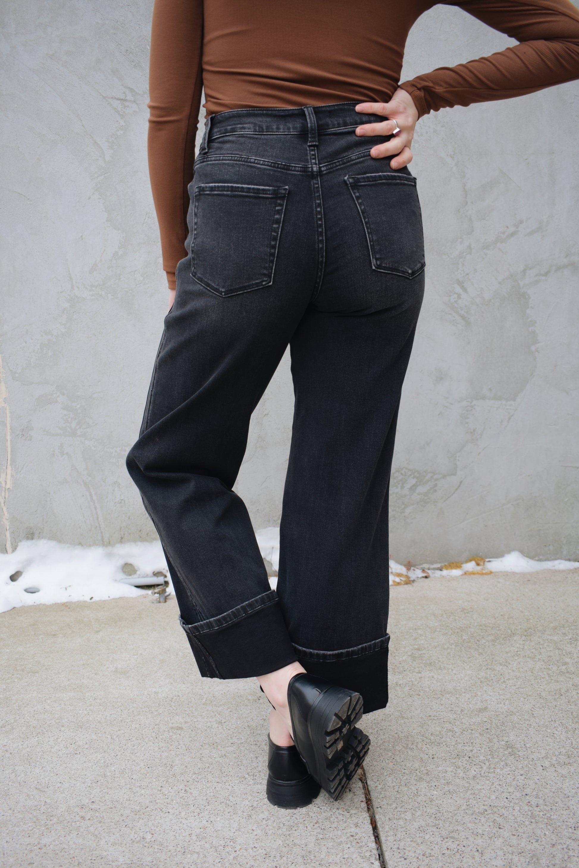 high rise stretch denim black wash no holes wide leg double panel with double front pocket has beltloops zip and button enclosure wide cuff at hem that can be uncuffed