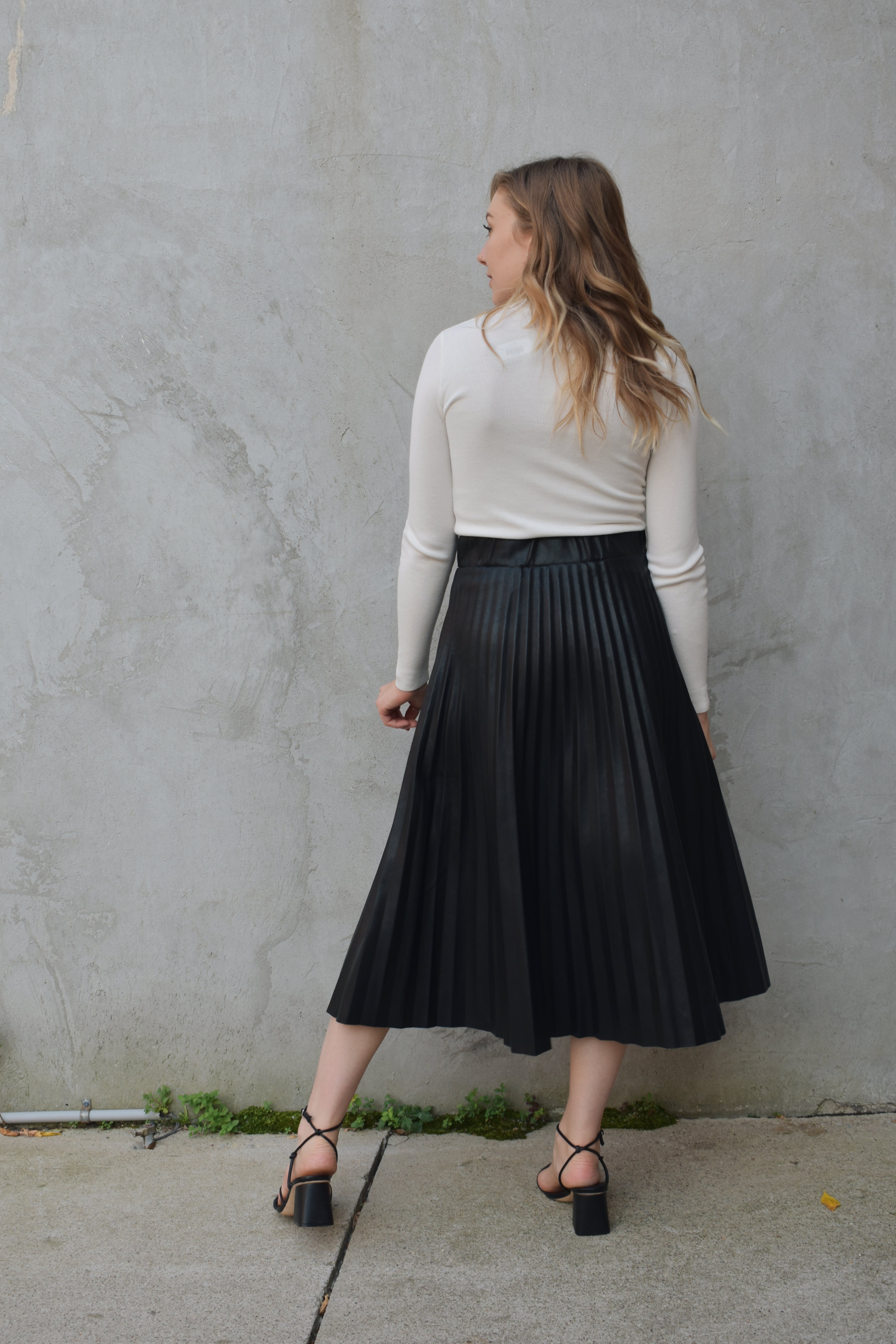 Pinch pleated pleather vegan leather midi skirt in black The Revival