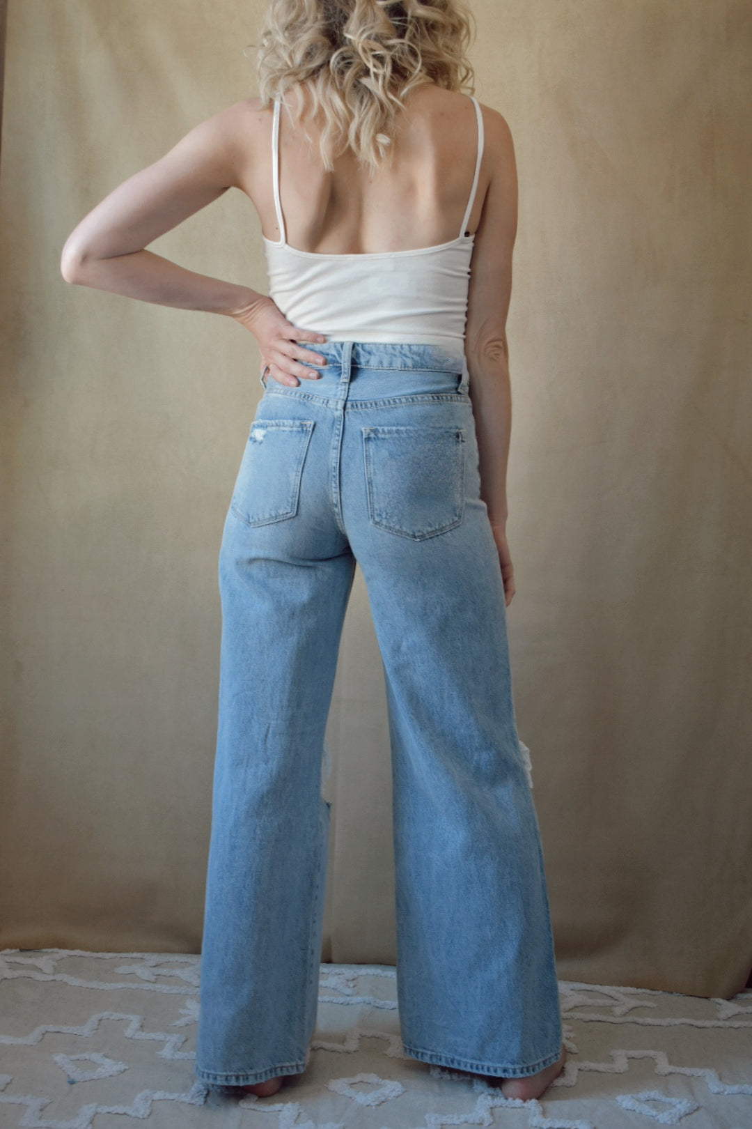 Hyfve. Cropped cami that comes in white, taupe and black. scoops lower in the back. spaghetti straps. 